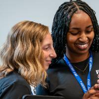 Two event guests looking at photo taken on phone